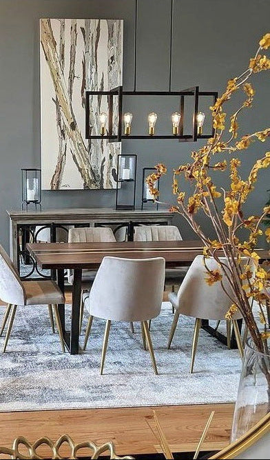 Dining room with wooden table, chairs, and decorative elements.