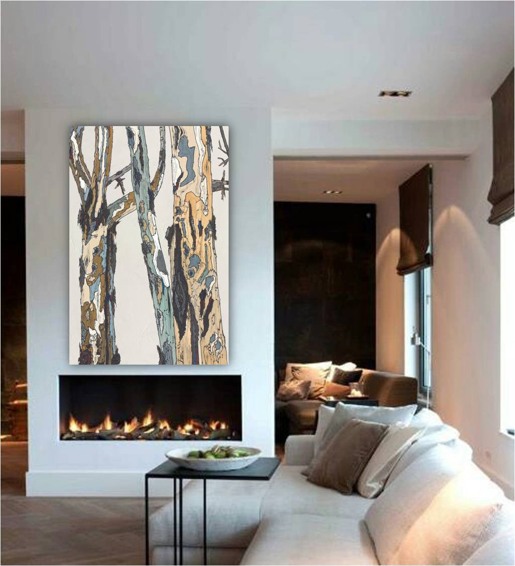 Vertical oversized canvas print of trees & landscape hung over a modern fireplace in a living room.