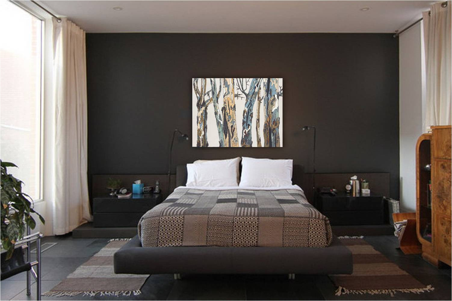 Large wall art canvas print of tree landscape in a masculine bedroom on a very dark wall above the bed.