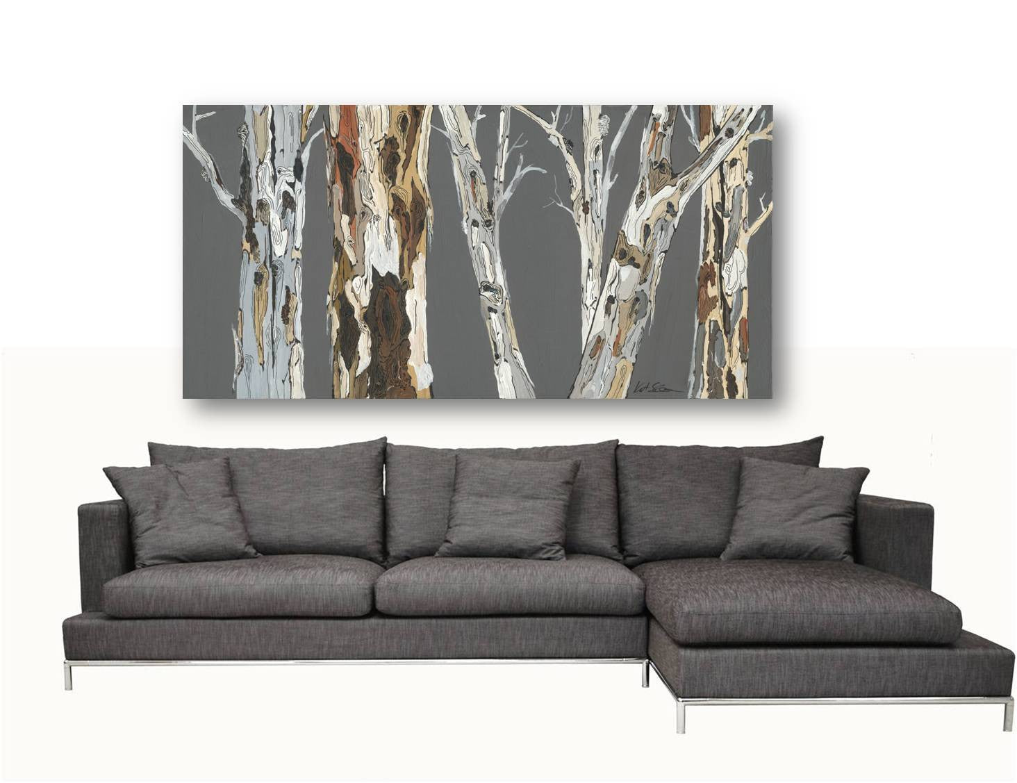 Extra large canvas art of trees in gray and muted colors above a huge contemporary sectional