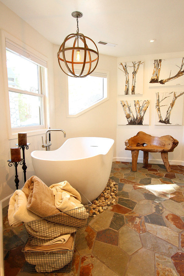Set of Four Canvas art tree prints on Large Wall in a rustic modern bathroom