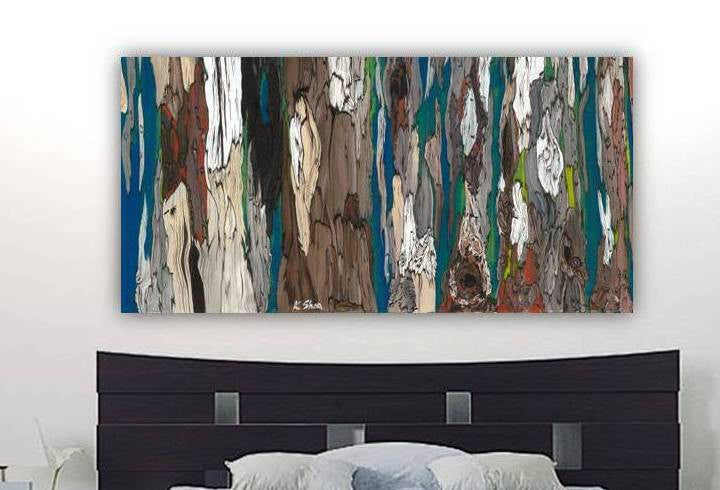 Abstract canvas art of tree landscape in blues and browns over a bed in transitional decor bedroom
