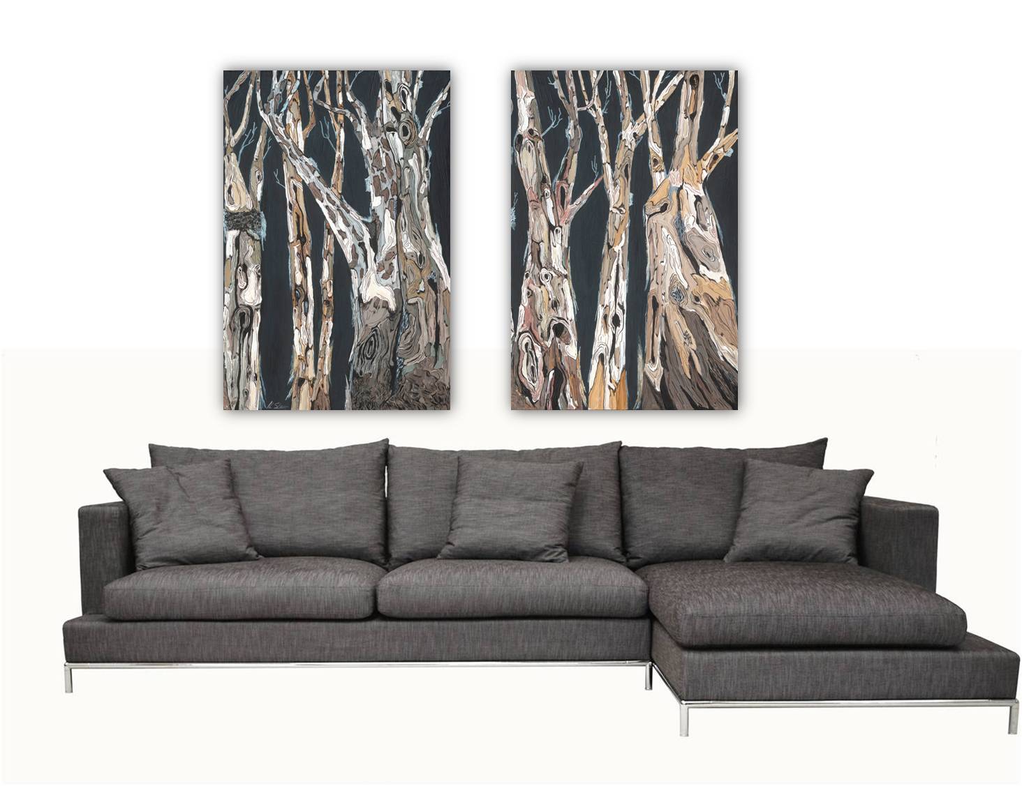 A diptych canvas wall art featuring a black and white image of birch trees, displayed above a modern gray sofa.