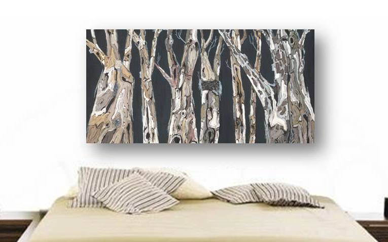 Striking horizontal dark charcoal, brown, and white tree landscape canvas print on a large wall above a large bed.