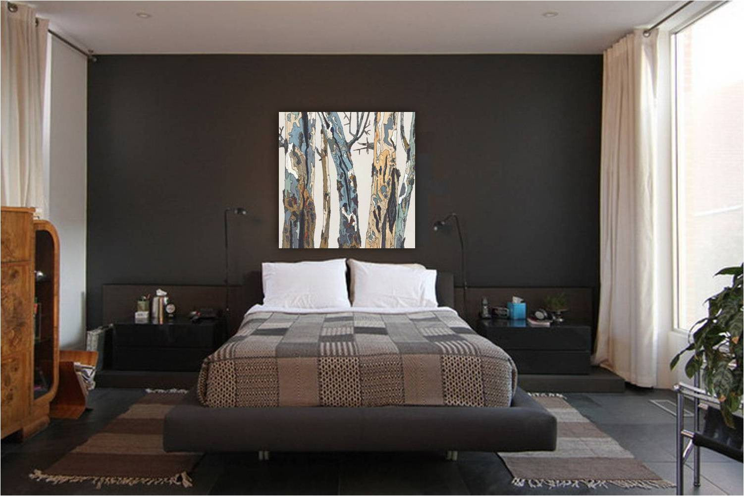 Striking large canvas art print in light colors on a dark wall in a moody masculine bedroom