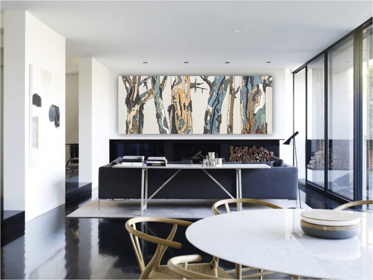 Extra wide canvas art print of tree landscape - above a wide modern fireplace in well lit space