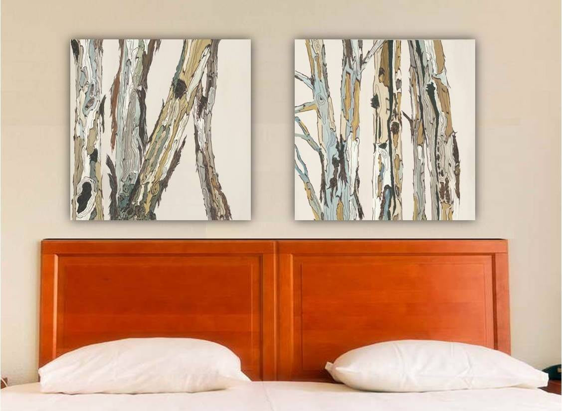 A set of two white canvas wall art prints featuring a rustic design with tree patterns, displayed above a bed in a transitional modern bedroom.