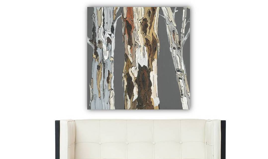 Large Tree Trunks Landscape gray artwrok on white wall above modern seat