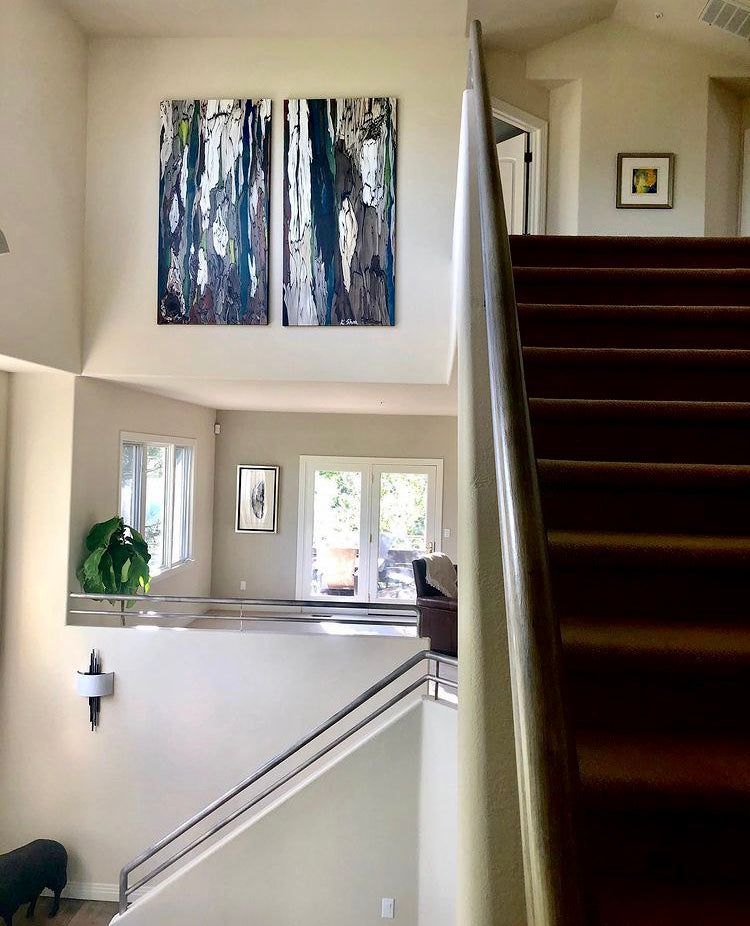 Oversized (6 feet tall) diptych canvas art prints of abstract trees hung above the tall ceiling entryway